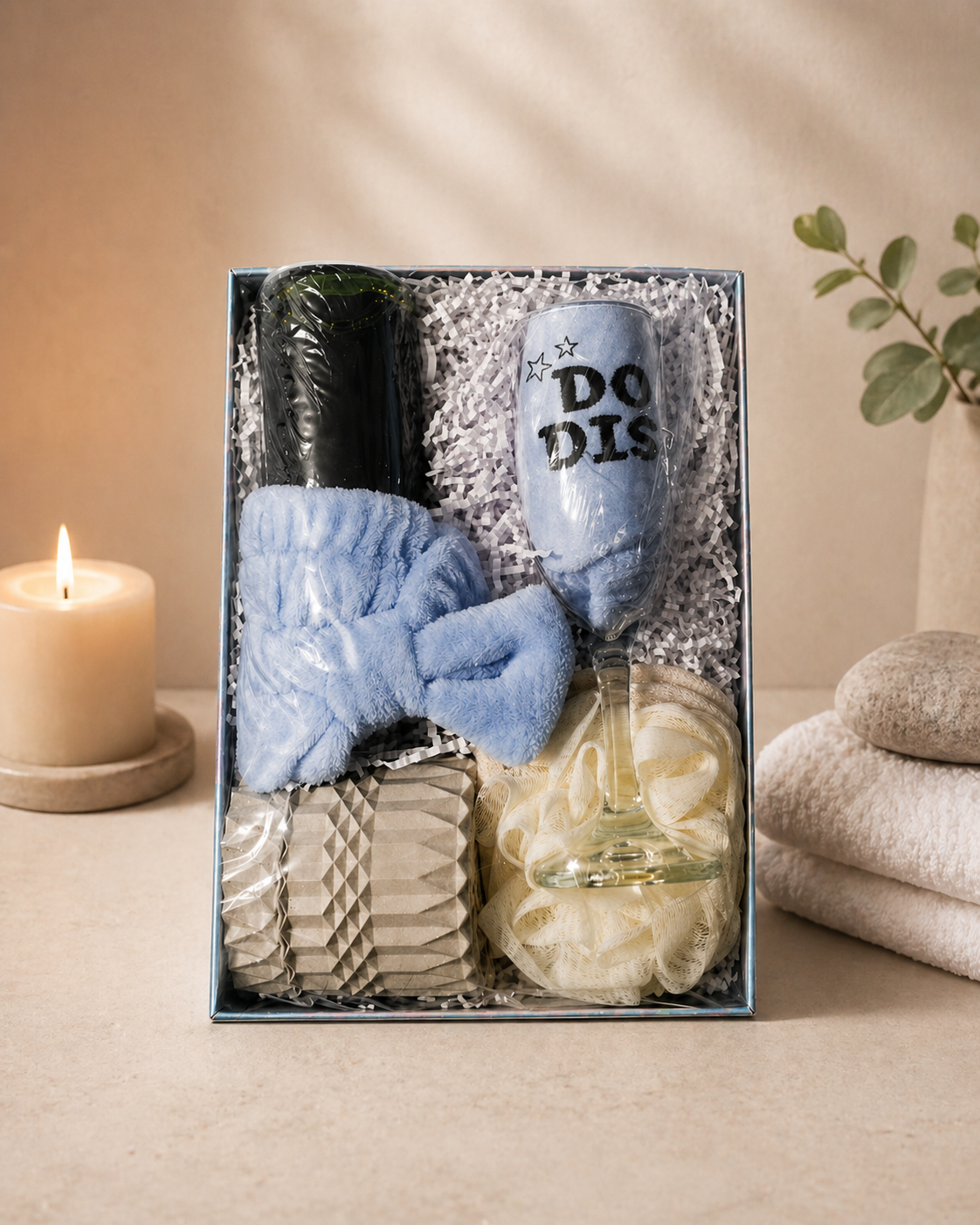 A large, premium Mother’s Day gift box featuring a 7oz candle, an eye mask, a wine glass, sparkling cider, and bath accessories.
